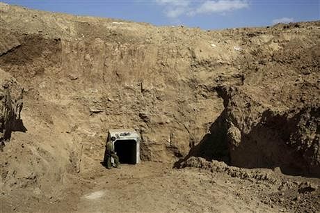  In this October 13, 2013 file photo, an Israeli soldier stands at the exit of a tunnel discovered near the Israel Gaza border. Photo: AP