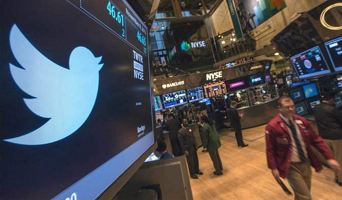 In this file photo taken November 8, 2013, the Twitter logo is displayed on the floor of the New York Stock Exchange. Twitter Inc made $243 million in revenue during the fourth quarter, topping investors' expectations in its first quarterly report as a public company. 