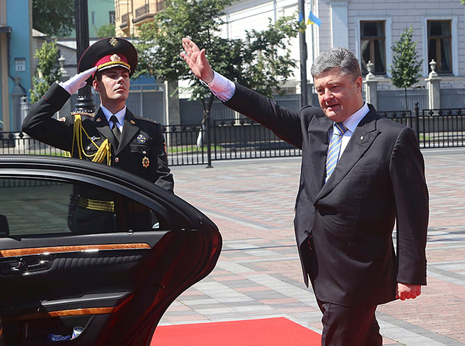 Ukraine's new president Petro Poroshenko waves as he leaves his inauguration ceremony in Kiev on Saturday.  Poroshenko took the oath today as Ukraine's president, buoyed by Western support but facing an immediate crisis in relations with Russia as a separatist uprising seethes in the east of his country. Photo: Reuters