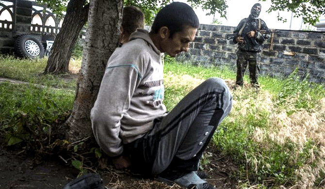 Inside Sloviansk, rebels detained suspected looters on Thursday. Photo: AP