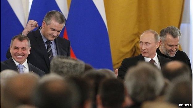 Crimea's head of government celebrated as the signing was completed. Photo: Reuters
