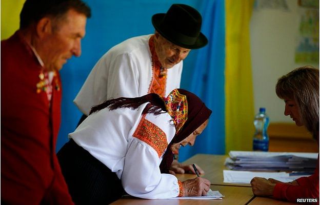 This couple in traditional dress were among the early voters in the western village of Kosmach, but in parts of troubled eastern Ukraine, no polling stations opened at all. Photo: Reuters