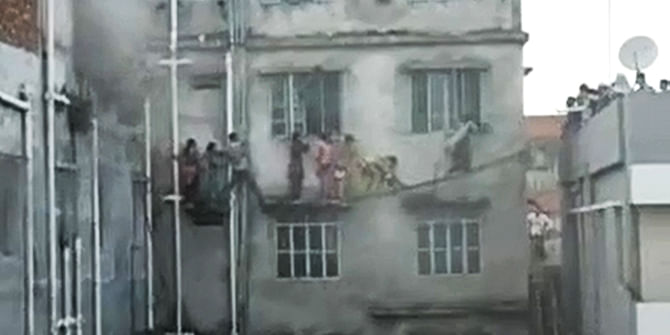 This grabbed photo of a video shows the trapped garment workers of Cordial Design Ltd are rescued by locals after the factory’s third flood caught fire on Sunday afternoon. A youth named Sabbir Ahmed recorded the video during the incident.