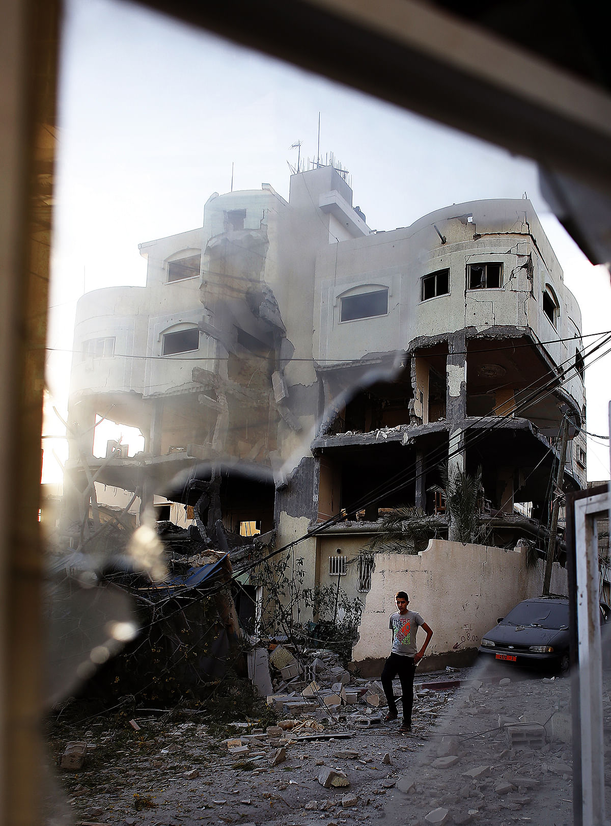 A Palestinian man walks past the house of senior Hamas official Mahmud al-Zahar after it was destroyed by an overnight Israeli air strike, on July 16, 2014, in Gaza City. Photo: Getty Images