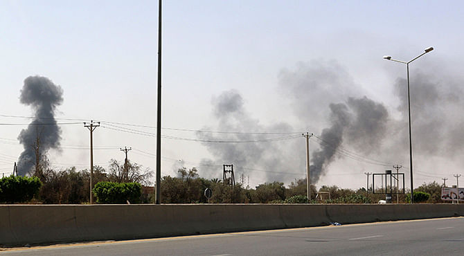 Smoke rises over the Airport Road area after heavy fighting between rival militias broke out near the airport in Tripoli July 25. Photo: Reuters 