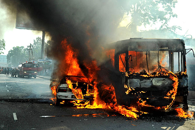 Blockaders set a BRTC bus and a private car on fire in front of Rajuk Bhaban at Motijheel in Dhaka on Tuesday.
