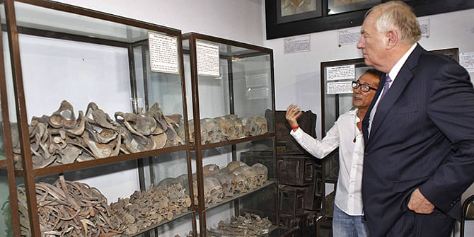 Stephen J Rapp, US ambassador-at-large for war crimes issues, looks at the remains of some of the country's martyrs at Liberation War Museum in the capital on Monday, accompanied by Akku Chowdhury, a freedom fighter also a trustee of the museum. Photo: Star