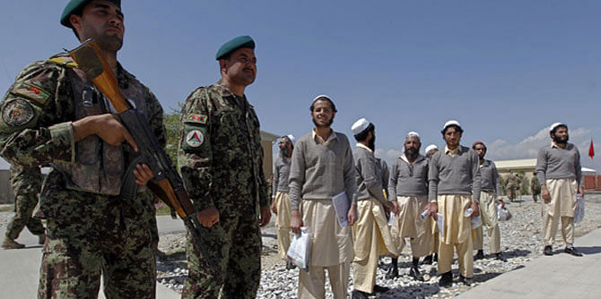 This Reuters file photo shows Afghan National Army soldiers escorting newly freed prisoners after a ceremony handing over the Bagram prison to Afghan authorities, at the US airbase in Bagram, north of Kabul in 2012