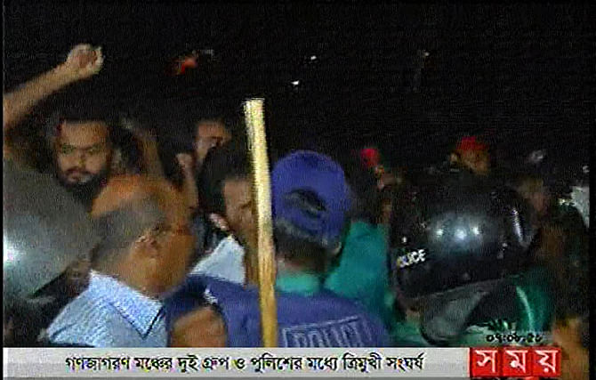 Policemen cordon Imran H Sarker and activists of his group during a factional clash with Kamal Pasha-led group at Shahbagh in the capital city of Dhaka on Friday. Photo: TV grab 
