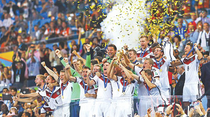 German players celebrate with the World Cup after beating Argentina in the final at the Maracana in Rio de Janeiro of Brazil on July 13. Germany won the trophy for the fourth time. File photo.