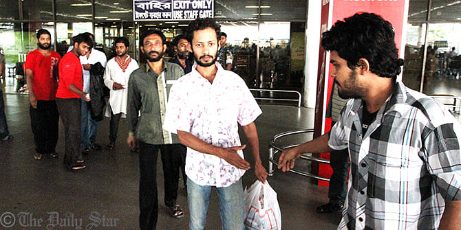 Bangladeshi migrant workers, who were reportedly deported by the Omani authorities, arrive at Hazrat Shahjalal International Airport Friday morning. Photo: Palash Khan